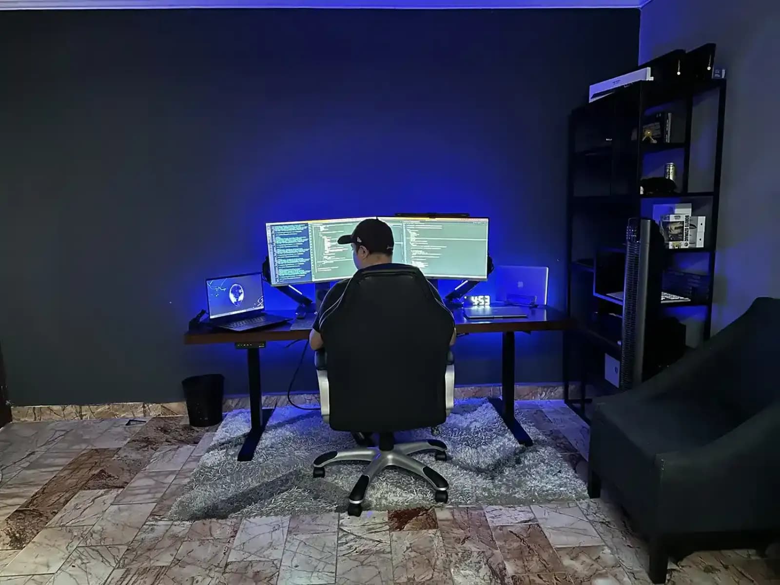 Jorge Saurina working at his desk in front of three monitors